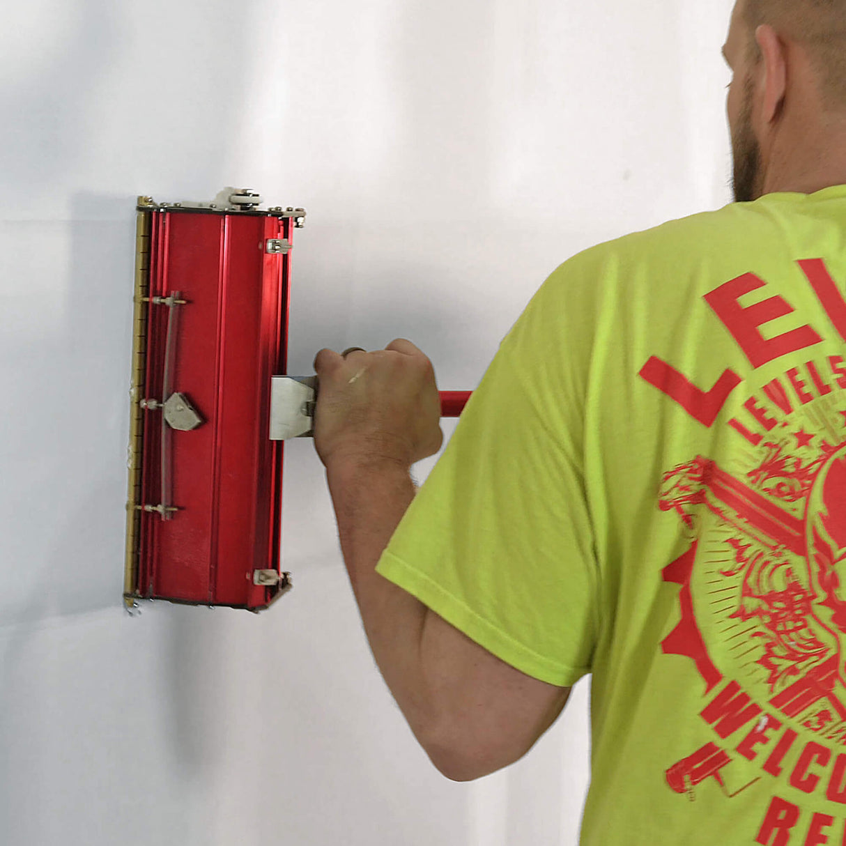 Person running a red Level 5 flat box attached to a Level 5 fixed flat box handle across an unifinished wall joint