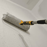 TapeTech Compound Roller Support Handle attached to a compound roller applying mud onto the wall