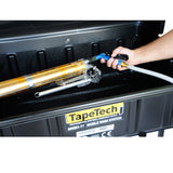 Close-up of a person using a TapeTech water sprayer to clean a TapeTech taper inside a wash basin
