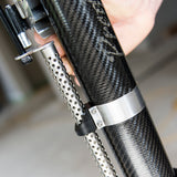 Close-up of hand holding black carbon fiber Columbia One Predator Automatic Taper body at the job site